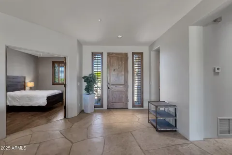 a living room with furniture and a floor to ceiling window