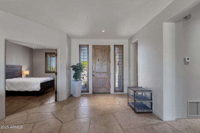 a living room with furniture and a floor to ceiling window