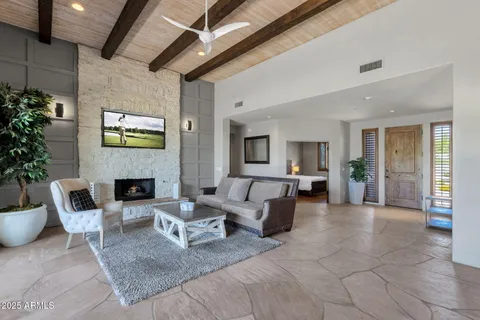 a dining room with furniture a chandelier and window