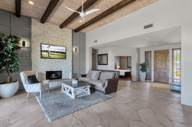 a dining room with furniture a chandelier and window