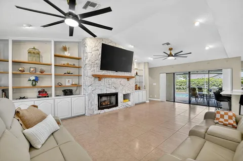 a living room with furniture fireplace and flat screen tv