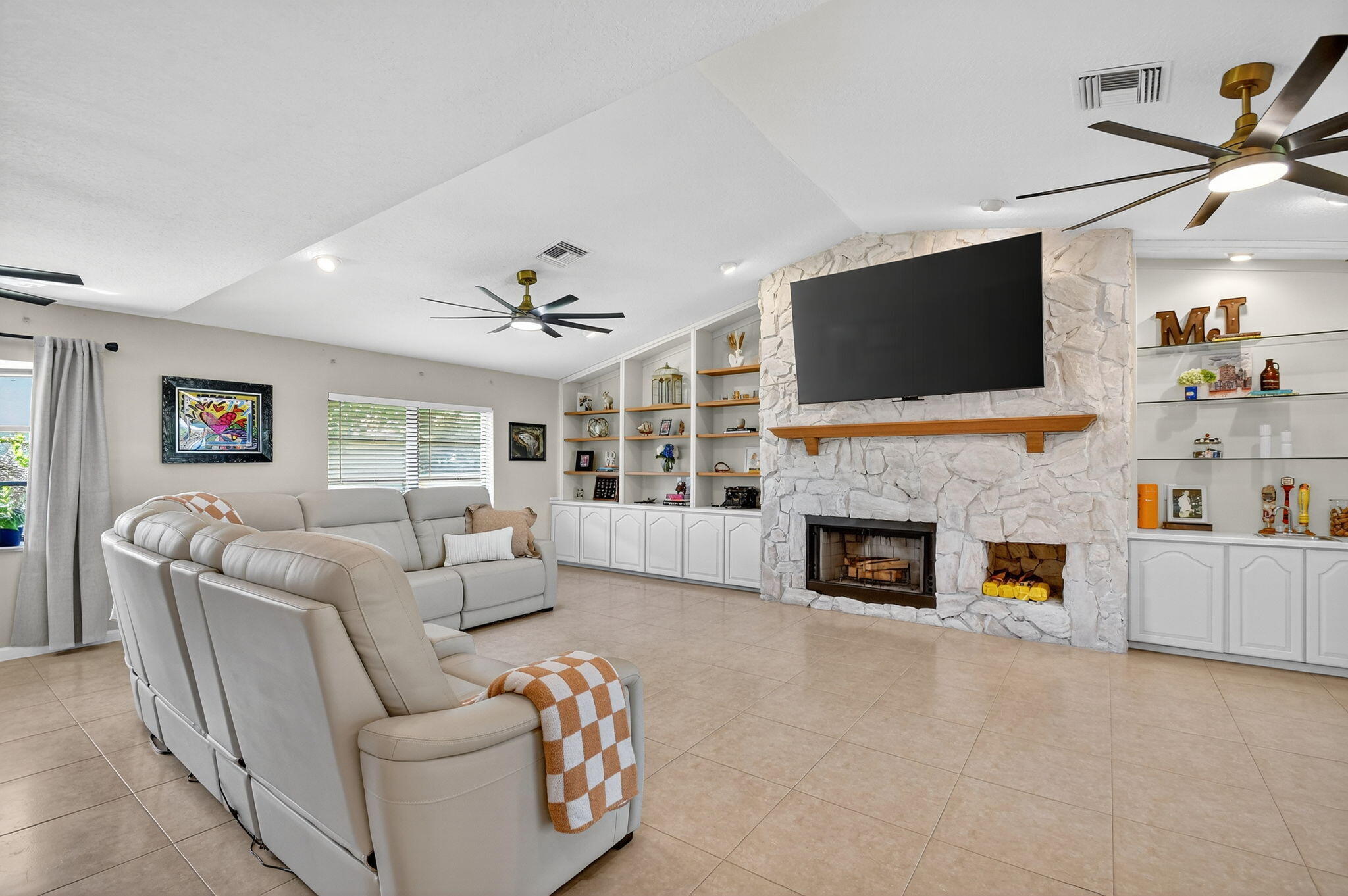 4270 Fox Trace Road Boynton Beach, FL 33436 - Photo 12 of 46 a living room with furniture a fireplace and a flat screen tv