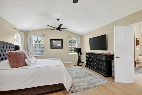 a bedroom with a bed and a flat screen tv