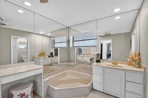 a large bathroom with a large tub and sink