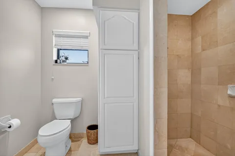 a white toilet sitting next to a bathroom sink