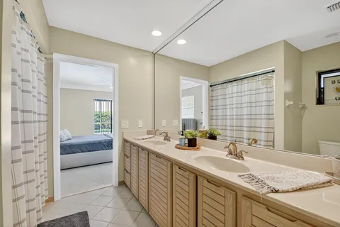 a bathroom with a granite countertop sink and a bathtub