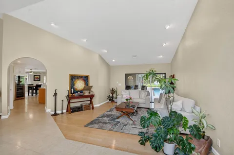 a living room with furniture fireplace and potted plant