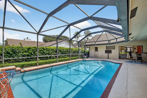 a view of a backyard with a tub and wooden fence