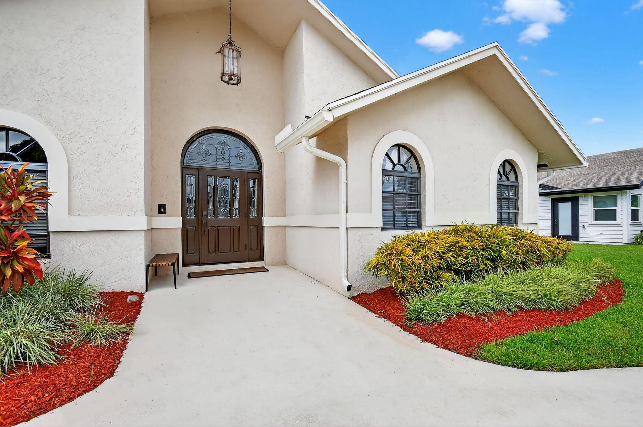 4270 Fox Trace Road Boynton Beach, FL 33436 - Photo 40 of 46 a front view of a house with a garden