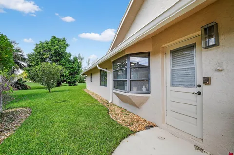 a view of house with backyard