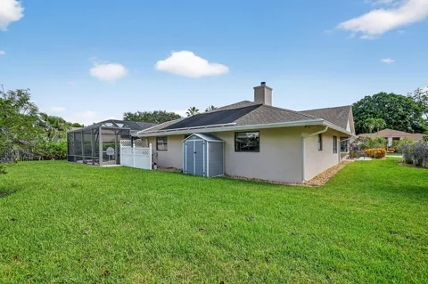 a front view of a house with a garden and plants