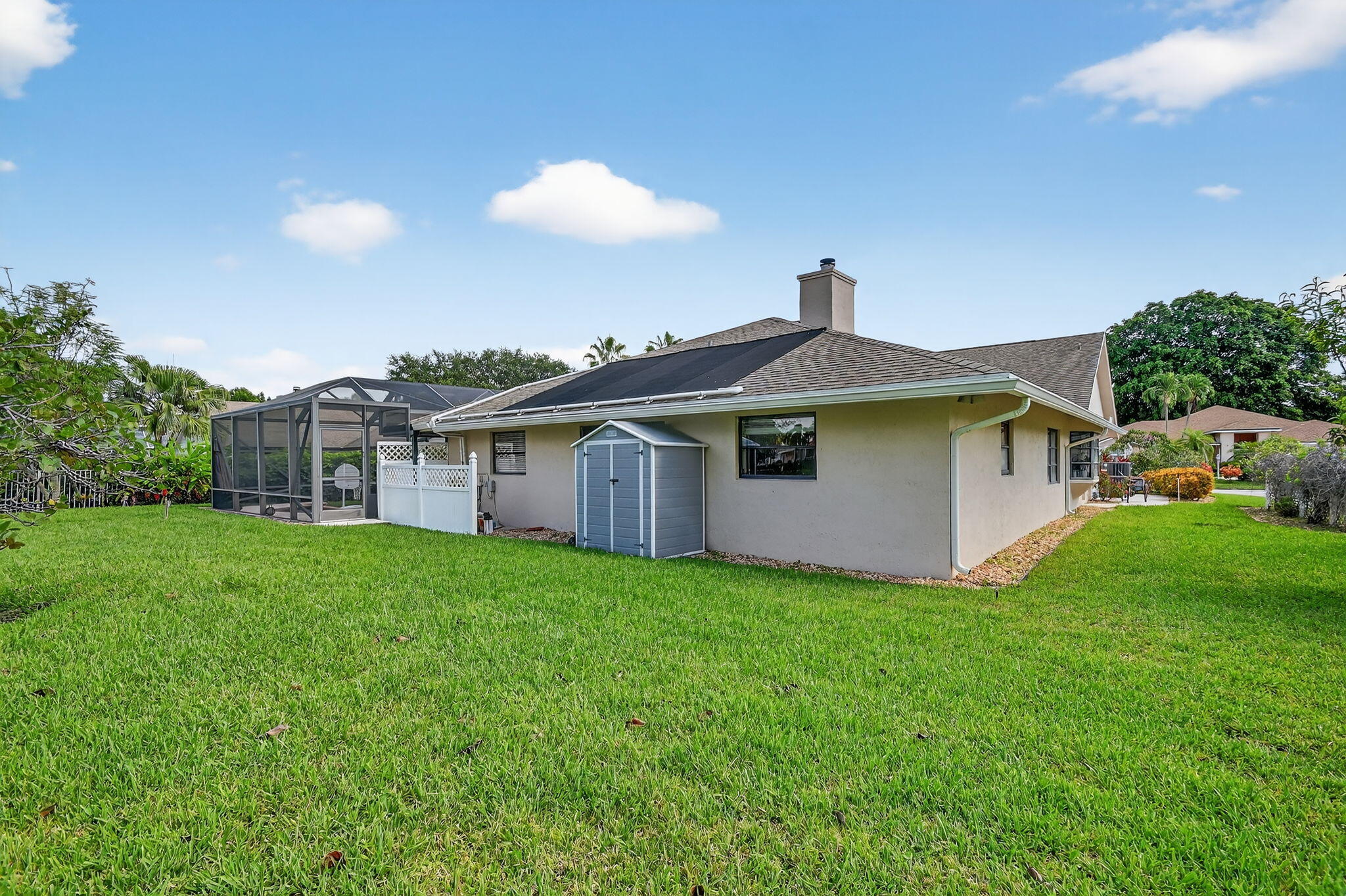 4270 Fox Trace Road Boynton Beach, FL 33436 - Photo 44 of 46 a front view of a house with a garden and plants