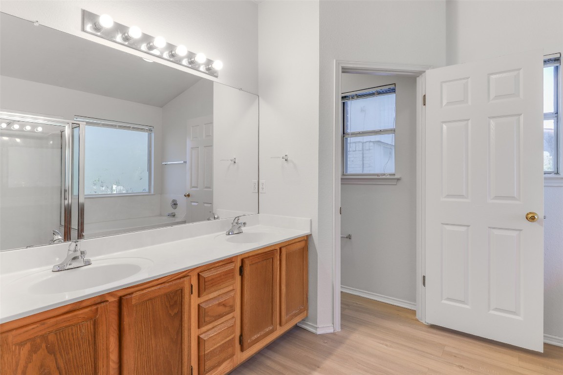 15437 Ozone Place Austin, TX 78728 - Photo 13 of 21 a bathroom with double sink and a mirror