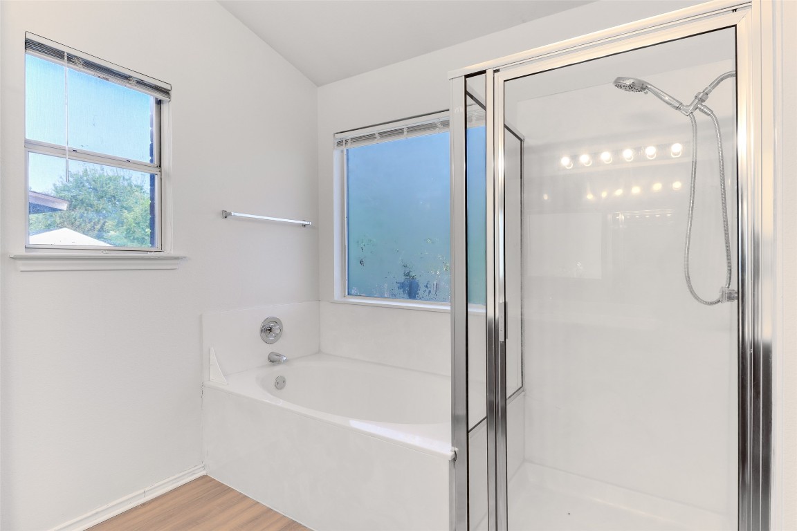 15437 Ozone Place Austin, TX 78728 - Photo 15 of 21 a bathroom with a bathtub and a shower