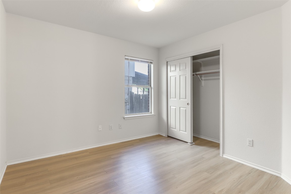 15437 Ozone Place Austin, TX 78728 - Photo 16 of 21 an empty room with wooden floor and windows