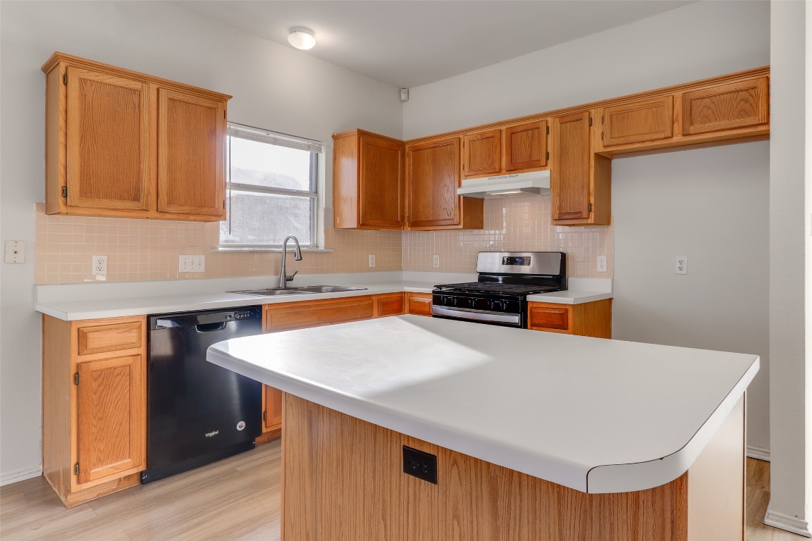 15437 Ozone Place Austin, TX 78728 - Photo 5 of 21 a kitchen with stainless steel appliances a sink dishwasher stove and refrigerator