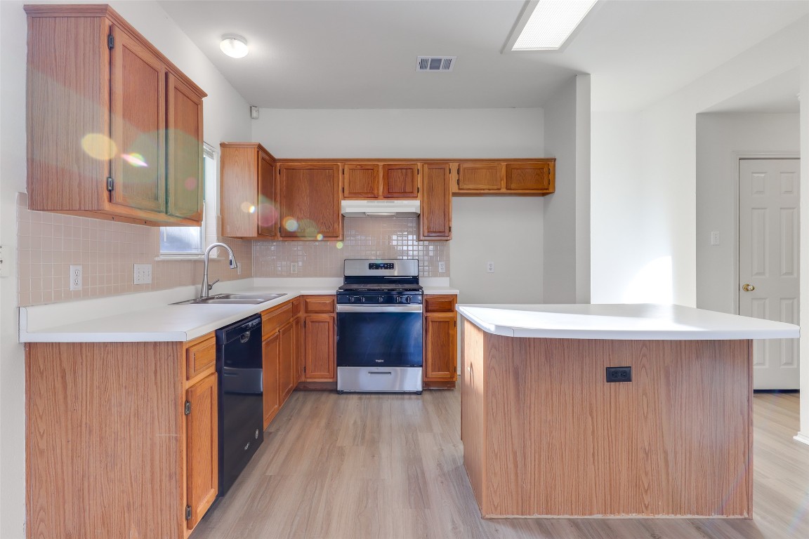 15437 Ozone Place Austin, TX 78728 - Photo 6 of 21 a kitchen with stainless steel appliances granite countertop a sink stove and refrigerator