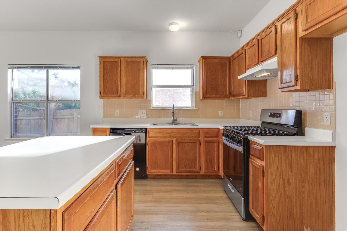 15437 Ozone Place Austin, TX 78728 - Photo 7 of 21 a kitchen with stainless steel appliances granite countertop a sink stove and refrigerator