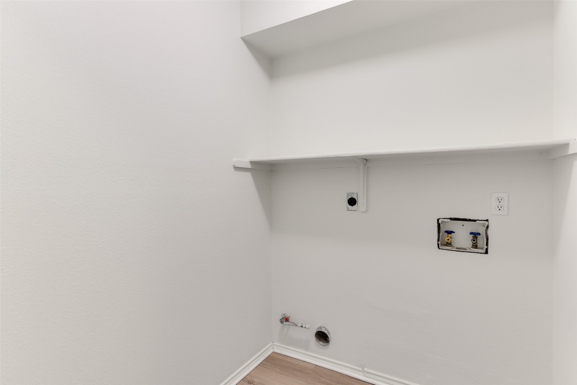 15437 Ozone Place Austin, TX 78728 - Photo 10 of 21 Laundry room featuring hookup for a gas dryer, hookup for a washing machine, and wood finished floors