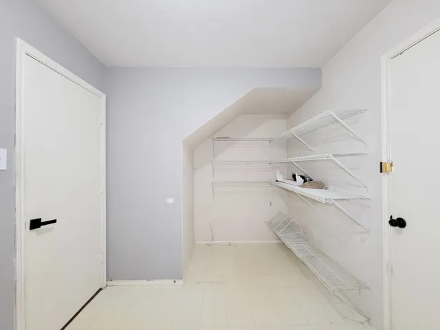 a view of storage and utility room with closet