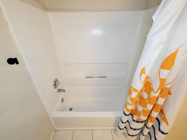 a bathroom with a bathtub and shower