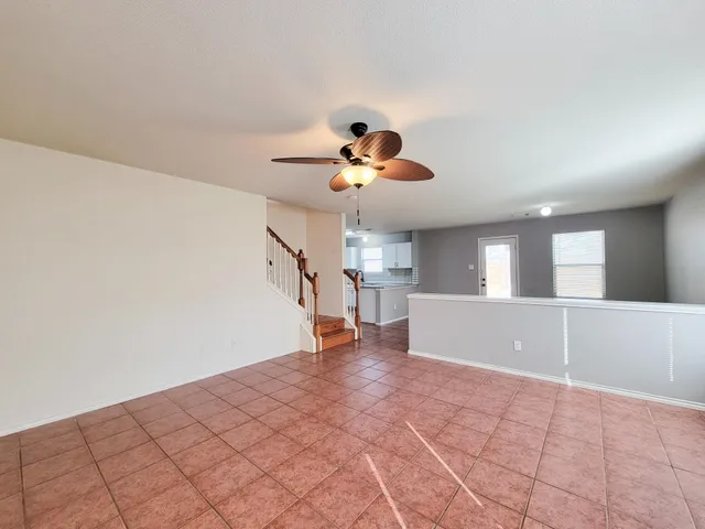 a view of a livingroom with a ceiling fan and window