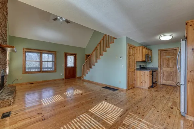 a view of a kitchen with wooden floor and a kitchen