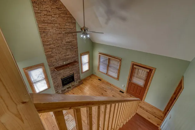 a view of a livingroom with wooden floor and staircase
