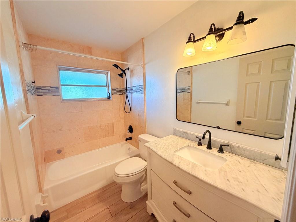 9017 Pineapple Road Fort Myers, FL 33967 - Photo 13 of 24 Bathroom featuring vanity, bathtub / shower combination, and light wood-style floors