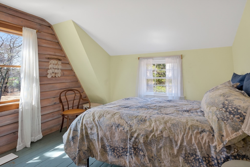 7 Pip'n Road Edgartown, MA 02539 - Photo 19 of 41 a bed sitting in a bedroom next to a window