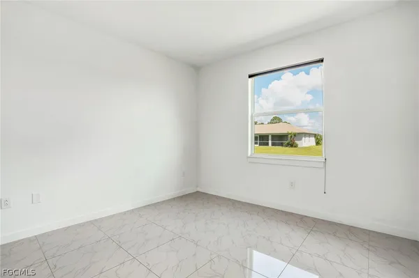 a view of an empty room with painting on the wall