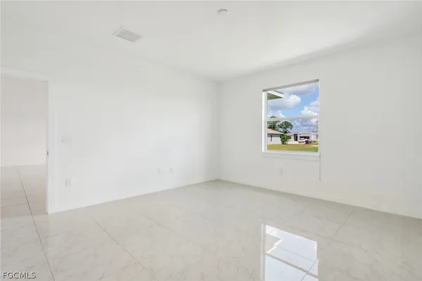 an empty room with a painting on the wall