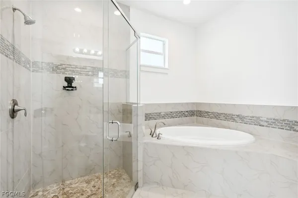 a bathroom with a tub and shower