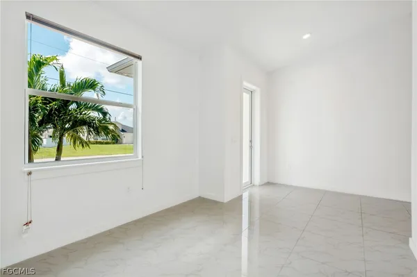 an empty room with windows and yard