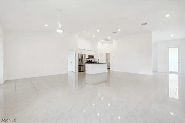 a view of kitchen with refrigerator and window