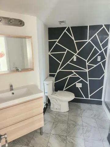 a white bath tub sitting next to a white cabinet and a shower