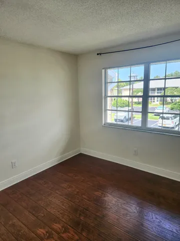 a view of a swimming pool with a patio and a yard