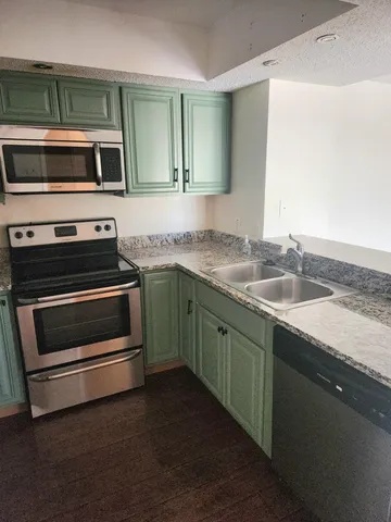 a kitchen with a sink and stainless steel appliances