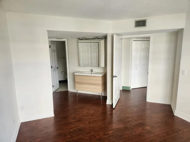 a view of a hallway with wooden floor