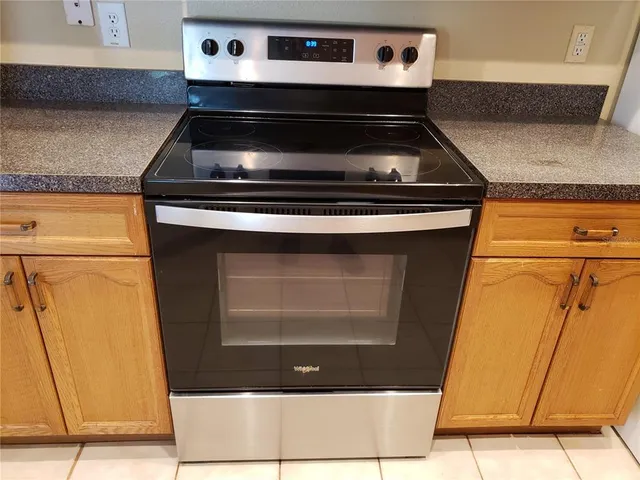 a stove top oven sitting inside of a kitchen