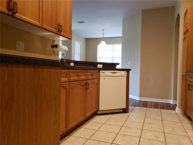 a kitchen with a stove top oven cabinets and a window