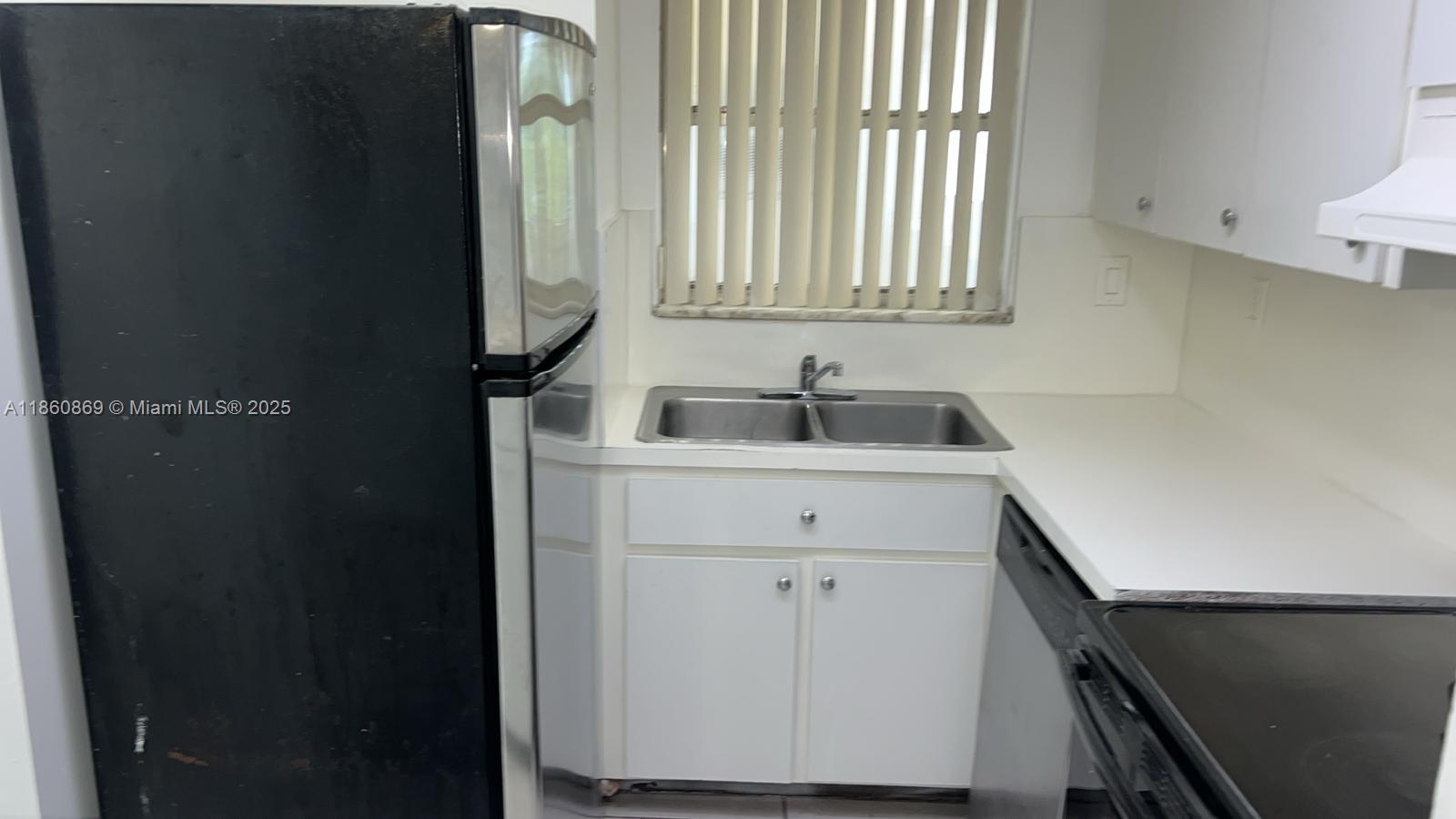 8860 Fontainebleau Boulevard, Unit 403 Miami, FL 33172 - Photo 11 of 13 a bathroom with a sink and a mirror