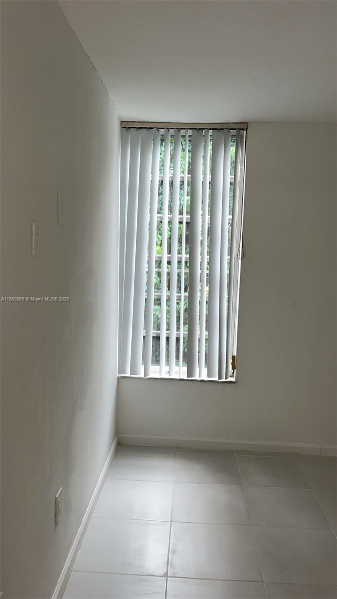 8860 Fontainebleau Boulevard, Unit 403 Miami, FL 33172 - Photo 13 of 13 a view of an empty room with a window