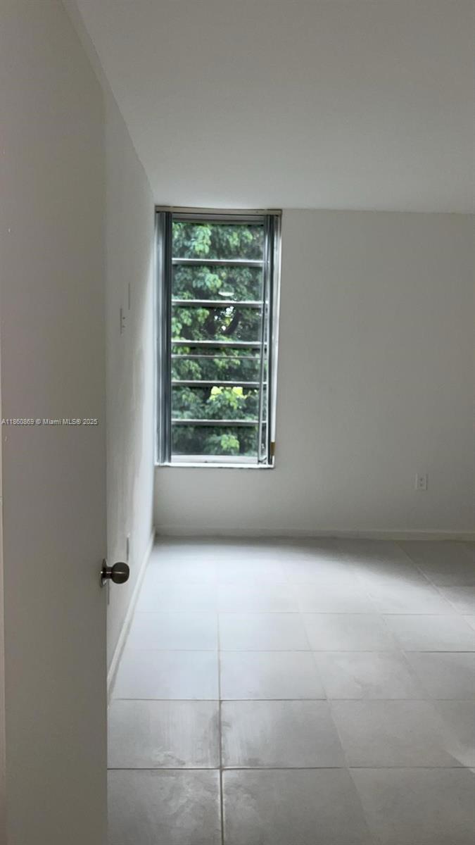 8860 Fontainebleau Boulevard, Unit 403 Miami, FL 33172 - Photo 3 of 13 a view of an empty room with a window