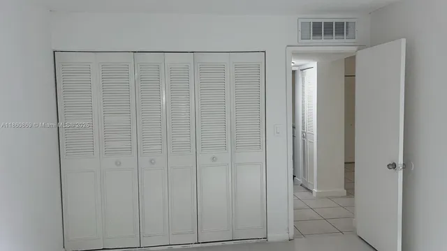 a white toilet sitting next to a white sink and vanity