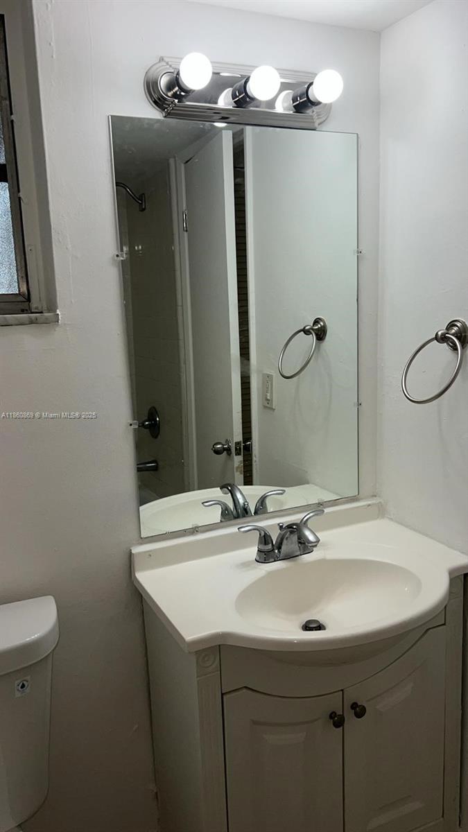 8860 Fontainebleau Boulevard, Unit 403 Miami, FL 33172 - Photo 7 of 13 a bathroom with a sink and mirror