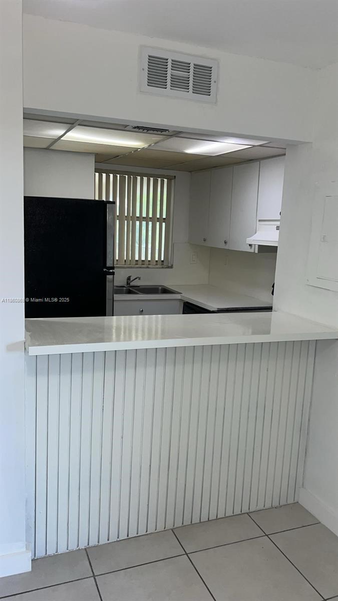 8860 Fontainebleau Boulevard, Unit 403 Miami, FL 33172 - Photo 9 of 13 a living room with a flat screen tv a rug and a walk in closet