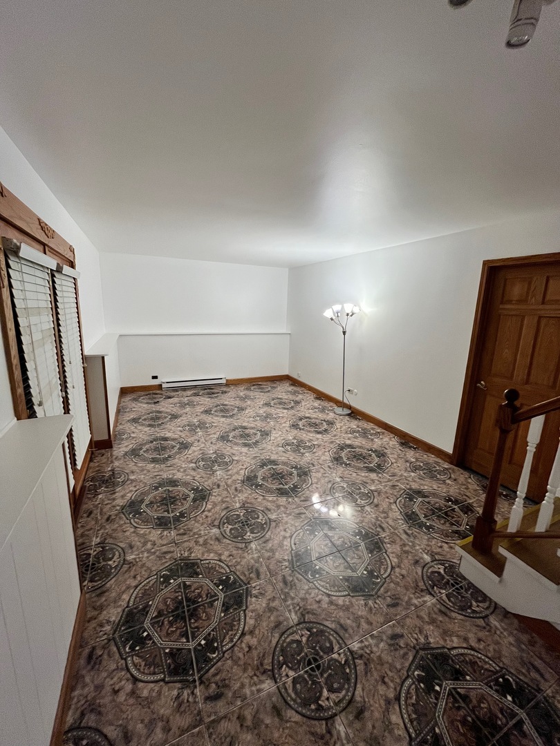 1927 Dugdale Road North Chicago, IL 60064 - Photo 22 of 36 a view of a room with rack and wooden floor