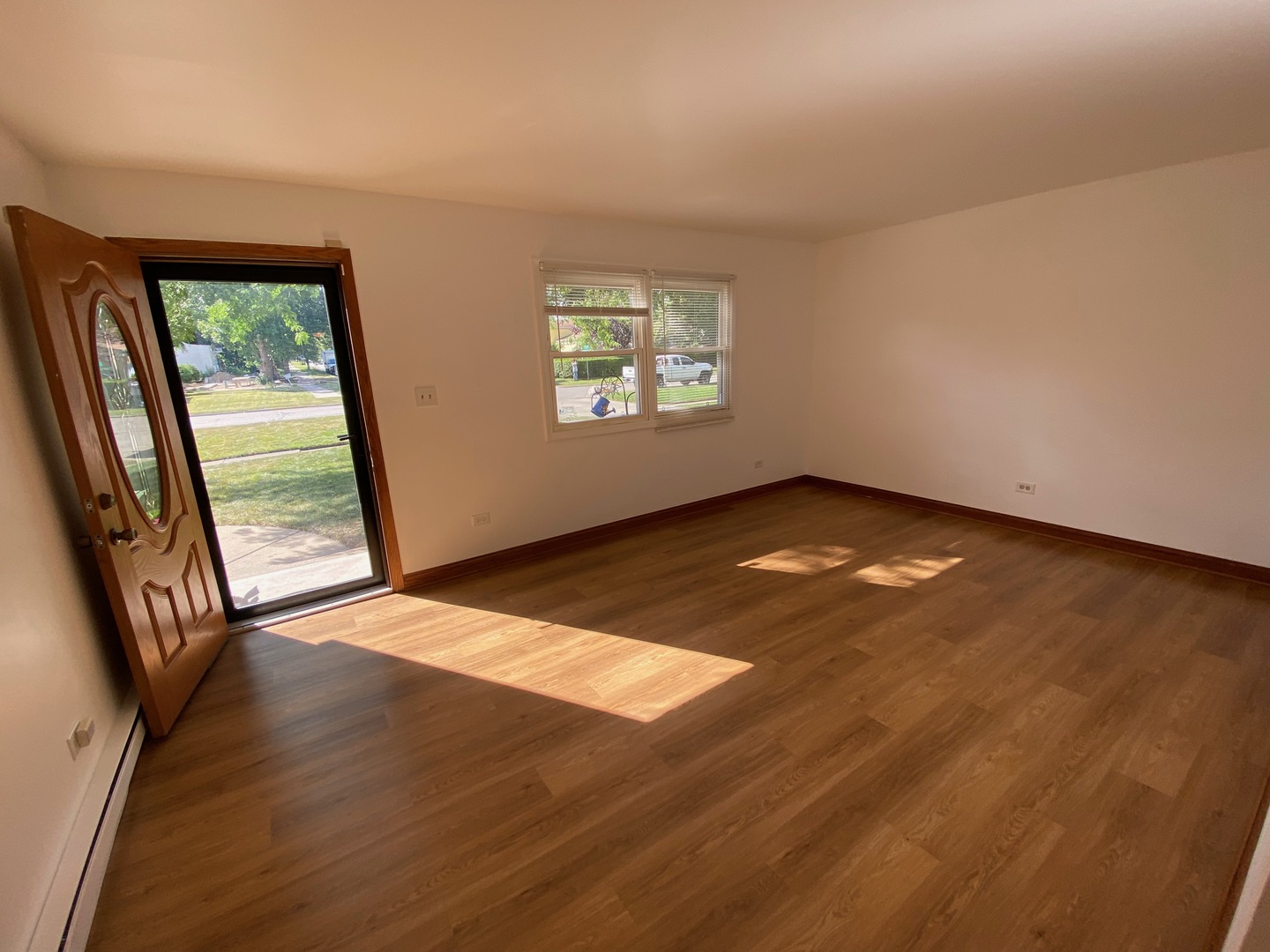 1927 Dugdale Road North Chicago, IL 60064 - Photo 5 of 36 an empty room with wooden floor and windows