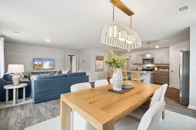 a kitchen with a dining table and chairs
